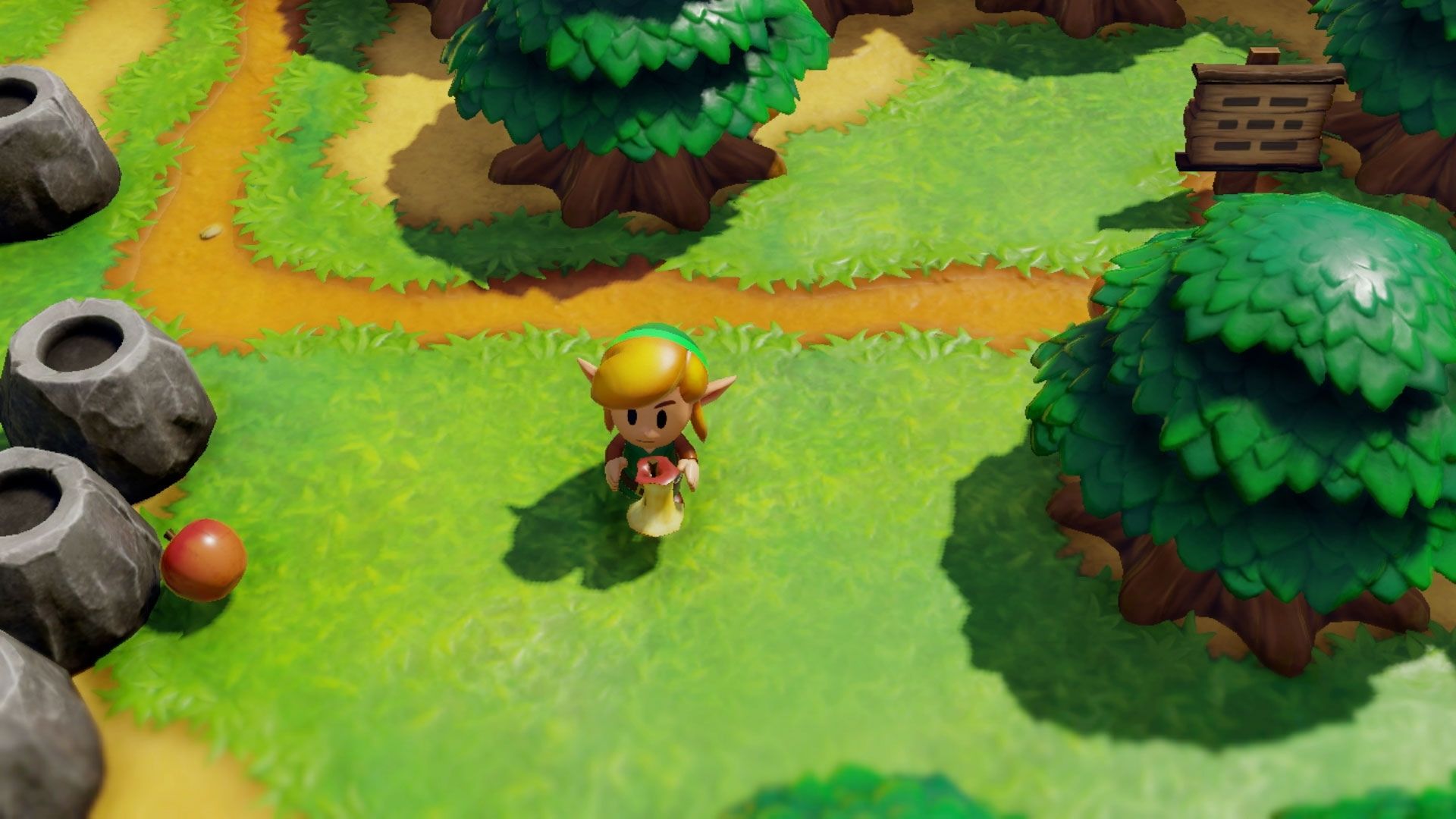 Link eats an apple in the woods in Link's Awakening.