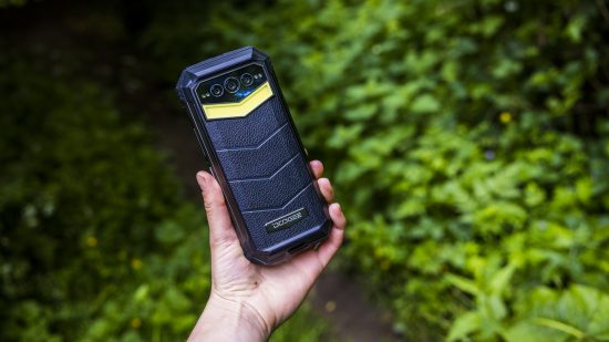 The Doogee S100 Pro rugged phone being tested in a wood