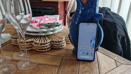 Custom image for Google Pixel 8a review showing the phone leaning against a vase